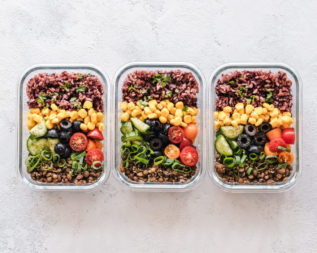 Meal Prep example of rice, lentils, and colorful veggies in glass containers.